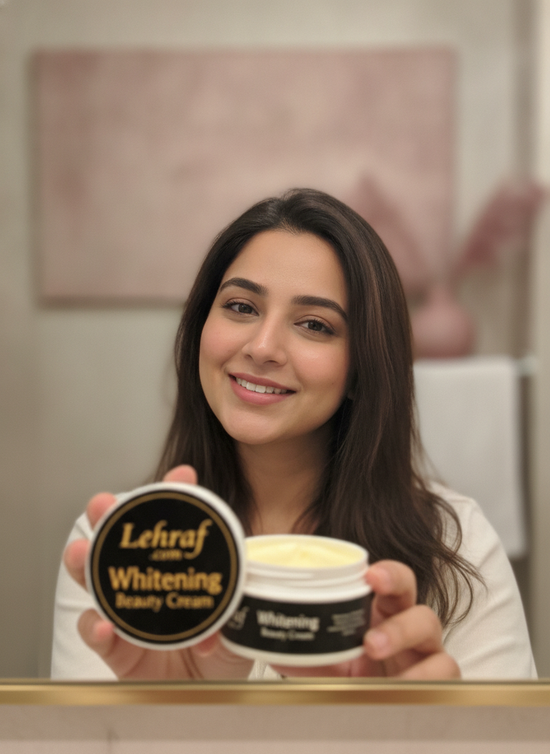 Close-up mirror selfie of a Pakistani woman with a radiant glow on her face before her wedding, holding Lehraf Whitening Beau